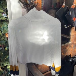 White knitted sweater with navy and gold striped sleeves